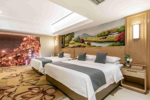 two beds in a room with a painting on the wall at Vienna Hotel Chongqing Jiefangbei Hongyadong in Chongqing