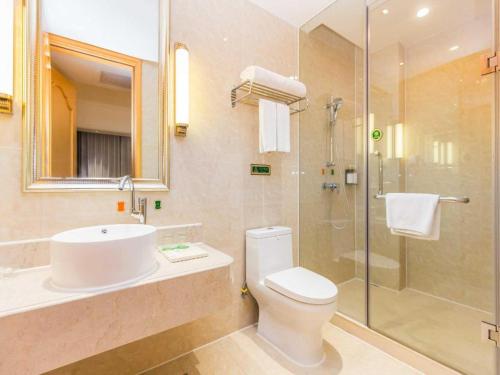 a bathroom with a toilet and a sink and a shower at Vienna Hotel Guangdong Foshan Wenhua North Road in Nanhai