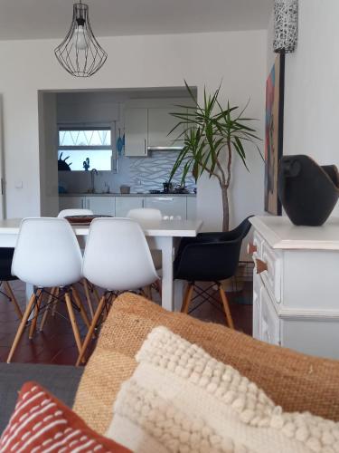 a kitchen and living room with a table and chairs at Garden Luz House in Lagos