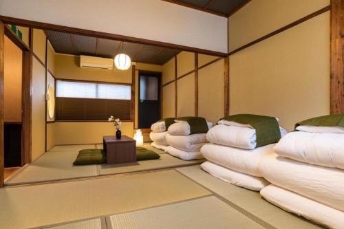 a room with three large white pillows on the floor at Bijou Suites Goen in Osaka