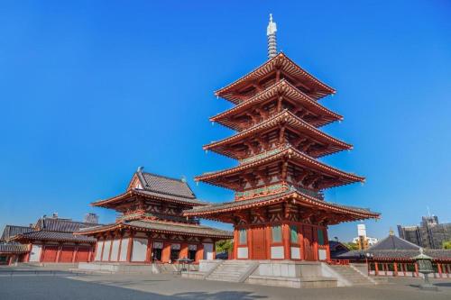 two large pagodas in front of a building at Bijou Suites Will in Osaka