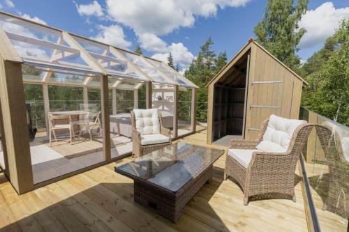 a gazebo with chairs and a table on a deck at Kosta Lodge in Kosta
