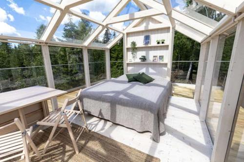a room with a bed in a glass house at Kosta Lodge in Kosta