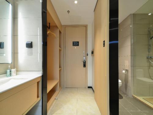 a bathroom with a shower and a sink and a toilet at City Comfort Inn Jingzhou Fantawild Shashi Middle School in Juzhang He