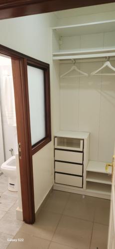 a bathroom with a sink and a toilet and a window at Kamuli Cottage in Entebbe