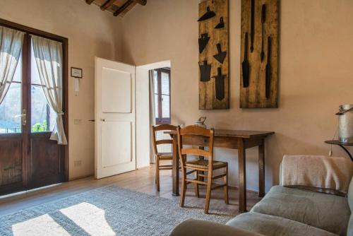 a living room with a table and chairs and a couch at Casa Zorzi in Arqua Petrarca