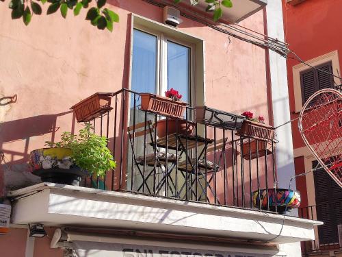 a balcony with potted plants and a window at Casa AL CORSO Pozzuoli Centro in Pozzuoli