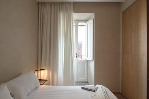 a bedroom with a white bed and a window at P10 DESIGN in Rome