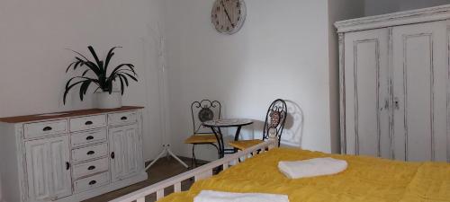 a bedroom with a bed and a dresser and a chair at Penzion U Šelongů in Jindrichuv Hradec