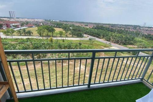 a balcony with a view of a field of grass at R&R Manjung Guest House at Pangsapuri Samudera in Seri Manjung