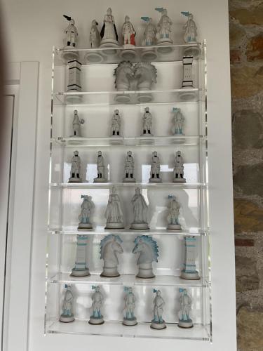 a shelf filled with figurines on top at Nuovo B&B Colline San Benedetto in Marostica
