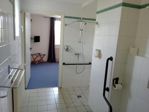 a bathroom with a shower with a glass door at L'Atelier Obelix familiale de 1 à 4 personnes in Saint-Symphorien-de-Marmagne