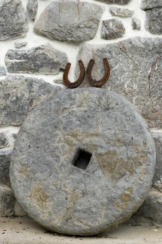 a rock with a sign on a stone wall at Holiday House Sobol in Kuželj