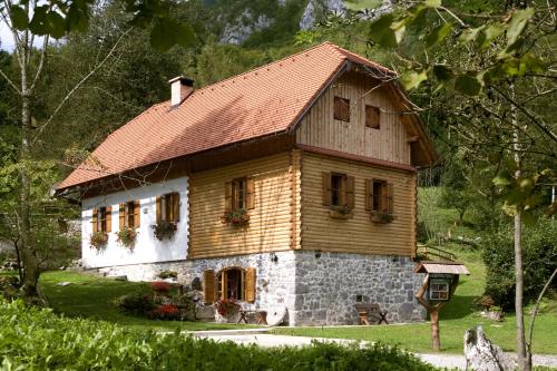 a small wooden house with a red roof at Holiday House Sobol in Kuželj