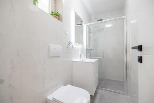 ein weißes Bad mit einem WC und einer Dusche in der Unterkunft Villa Matea Nin - Adriatic Luxury Villas in Nin
