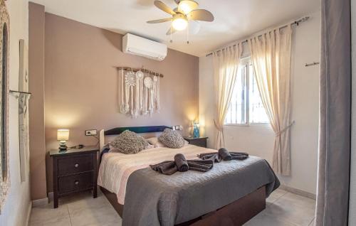 a bedroom with a bed and a ceiling fan at Urb, La Siesta in Torrevieja