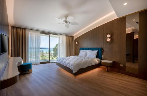 a bedroom with a bed and a large window at Star Boutique Hotel in Antalya