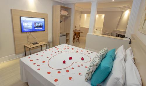 a bedroom with a bed with red hearts on it at Lizon Curitiba Hotel in Curitiba