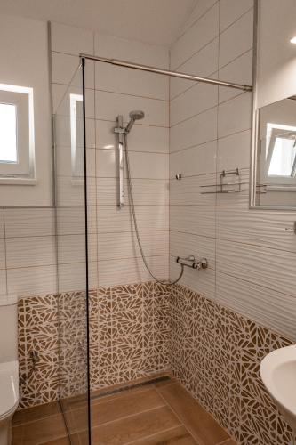 a bathroom with a shower and a sink at July's Guest House in Primorsko