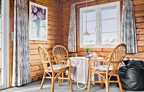 a dining room with a table and chairs at 3 Bedroom Amazing Home In Ringkøbing in Ringkøbing
