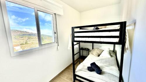 a bedroom with a bunk bed and a window at Vilaflor Naturaleza y Relax by Deihu Experiences in Vilaflor