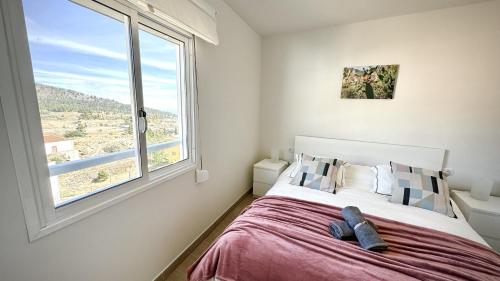 a bedroom with a bed with a large window at Vilaflor Naturaleza y Relax by Deihu Experiences in Vilaflor
