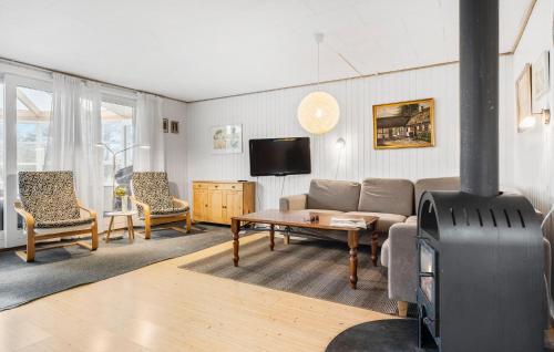a living room with a couch and a wood stove at 3 Bedroom Pet Friendly Home In Sydals in Sønderby