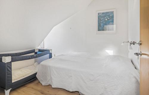 a white bedroom with a bed and a staircase at 2 Bedroom Nice Apartment In Lemvig in Lemvig