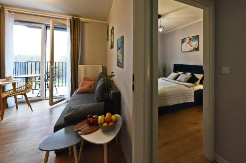 a living room with a couch and a table with fruit on it at SuperApart Prymasa 1000-lecia 6a, Hidden Gem - Ideal for Relaxation & Escapes in Rzeszów