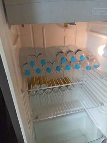 a refrigerator filled with lots ofbottles in a drawer at Rio foz camping para motorhome in Foz do Iguaçu