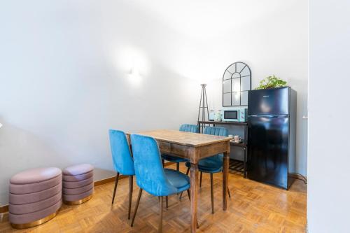 a dining room with a table and blue chairs at Panzani 13 in Florence