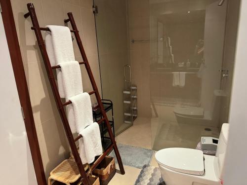 a bathroom with a toilet and a towel rack at Wonderful villa Harmony BangTao beach in Bang Tao Beach