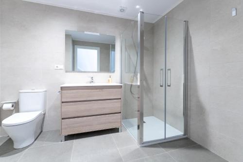 a bathroom with a shower and a toilet and a sink at Casa rural de lujo en Alt Urgell, Pirineos. in Aravell