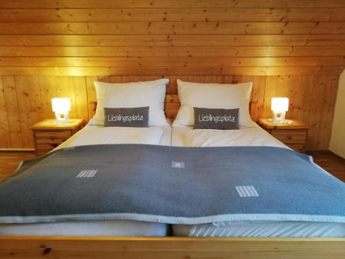 a bedroom with two beds and two lamps on night stands at Ferienhaus Karin in Rieding