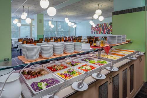 a buffet line with plates and food in a restaurant at Hotel Běhounek in Jáchymov