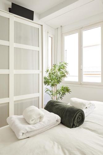 a bedroom with a bed with two towels on it at Low Cost Apartments Center Elche in Elche