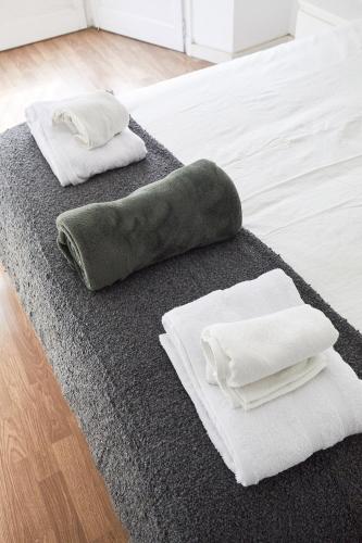 a bed with two pillows on top of it at Low Cost Apartments Center Elche in Elche