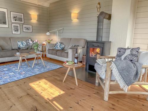 a living room with a couch and a fireplace at traumHaff Lotsen Romantik-Ostsee mit Kamin, privates NORDICSPA und Boot in Rieth