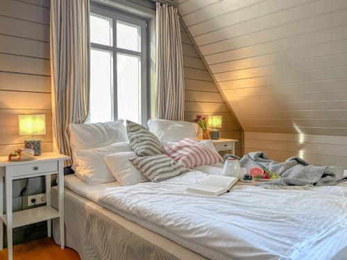 a large bed in a room with a window at traumHaff Lotsen Romantik-Ostsee mit Kamin, privates NORDICSPA und Boot in Rieth