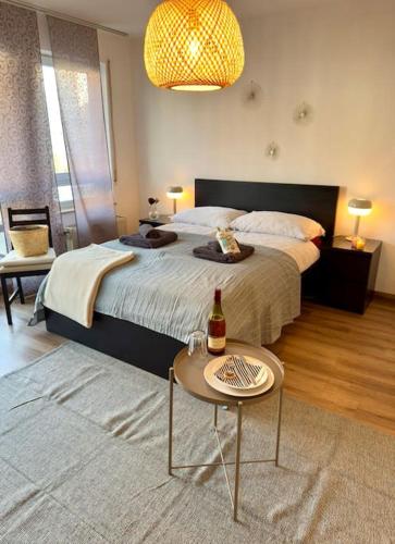 a bedroom with a bed and a table with a bottle on it at Südstadtoase • Tübingen &freeParking in Tübingen