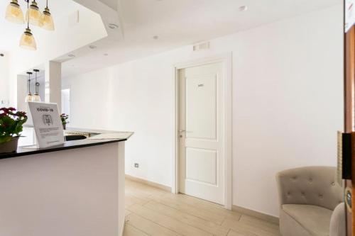 a white kitchen with a counter and a door at Mr. Charlie Brown in Rome