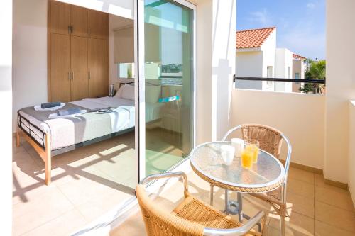 a balcony with a bed and a table and chairs at Villa Ivy in Protaras