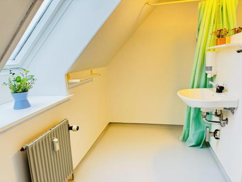 a bathroom with a sink and a window at aday - Stylish Central Apartment in Hjorring in Hjørring