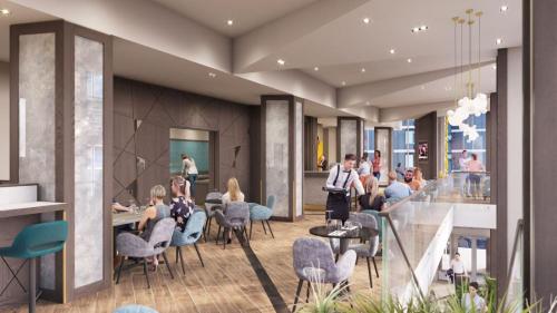 a rendering of a lobby with people sitting in chairs at Maldron Hotel Manchester Cathedral Quarter in Manchester