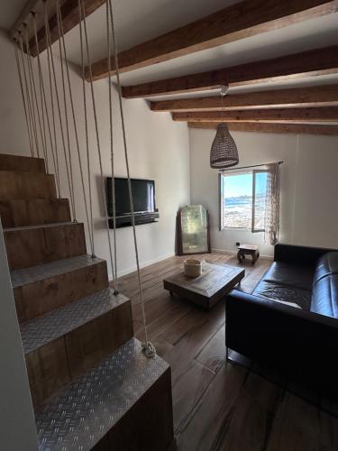 a living room with a staircase and a couch at Casa Mare, CABANON SUR LA PLAGE à Ajaccio vue sanguinaires in Ajaccio