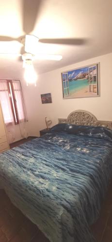 a bedroom with a large bed with a blue blanket at Gli scogli a due passi in Portovenere
