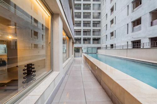 a swimming pool in the middle of a building at BHomy Melo in Sao Paulo