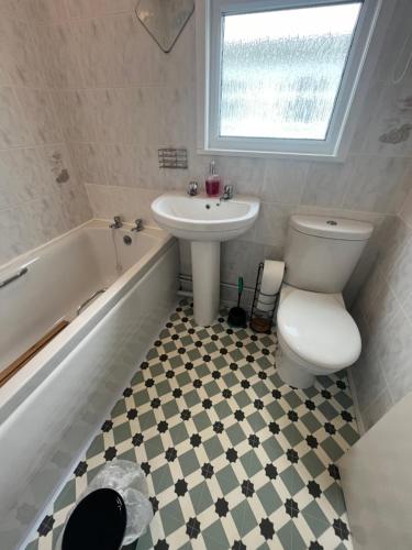 a bathroom with a sink and a toilet and a tub at Macs Shack, Two bed Chalet on California Sands Holiday Park - Sleeps 5, pet friendly, includes FREE pool passes - plus bed linen and towels included - only 300m from the beach! in Great Yarmouth