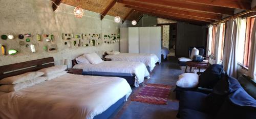 a bedroom with three beds in a room at Turismo Rural Lo Vilches in Chillán