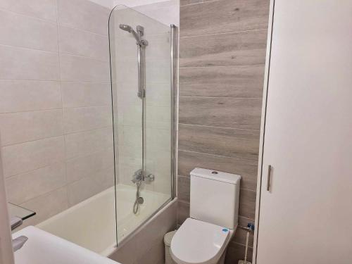 a bathroom with a shower and a toilet and a sink at Stylish Apt Kato Paphos Close to Beach & Vibrant Harbor Life in Paphos